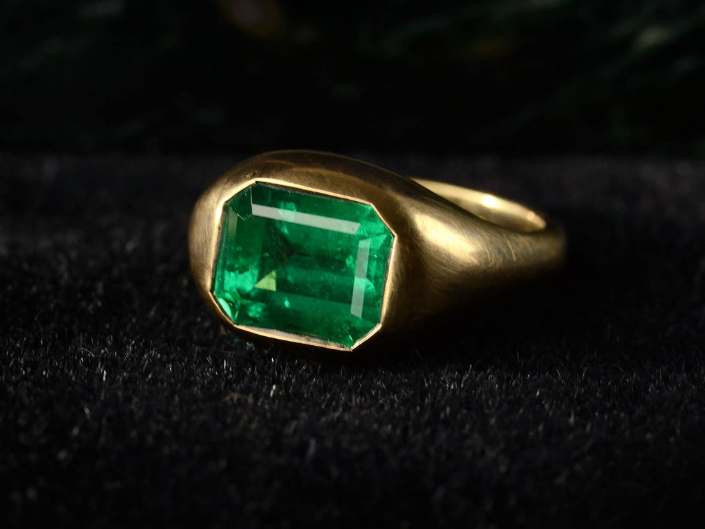 Elevated right front angle view of EB 3.64ct Emerald Ring in 22K Yellow Gold (on dark background)