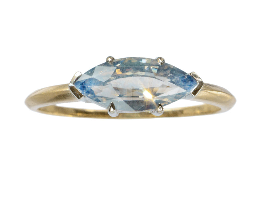 EB Modern ring with marquise-shaped light blue sapphire set in a simple platinum topped yellow gold mounting, shown on white background.