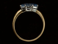 thumbnail of Side profile of EB Modern ring with marquise-shaped light blue sapphire set in a simple platinum topped yellow gold mounting, shown on black background.