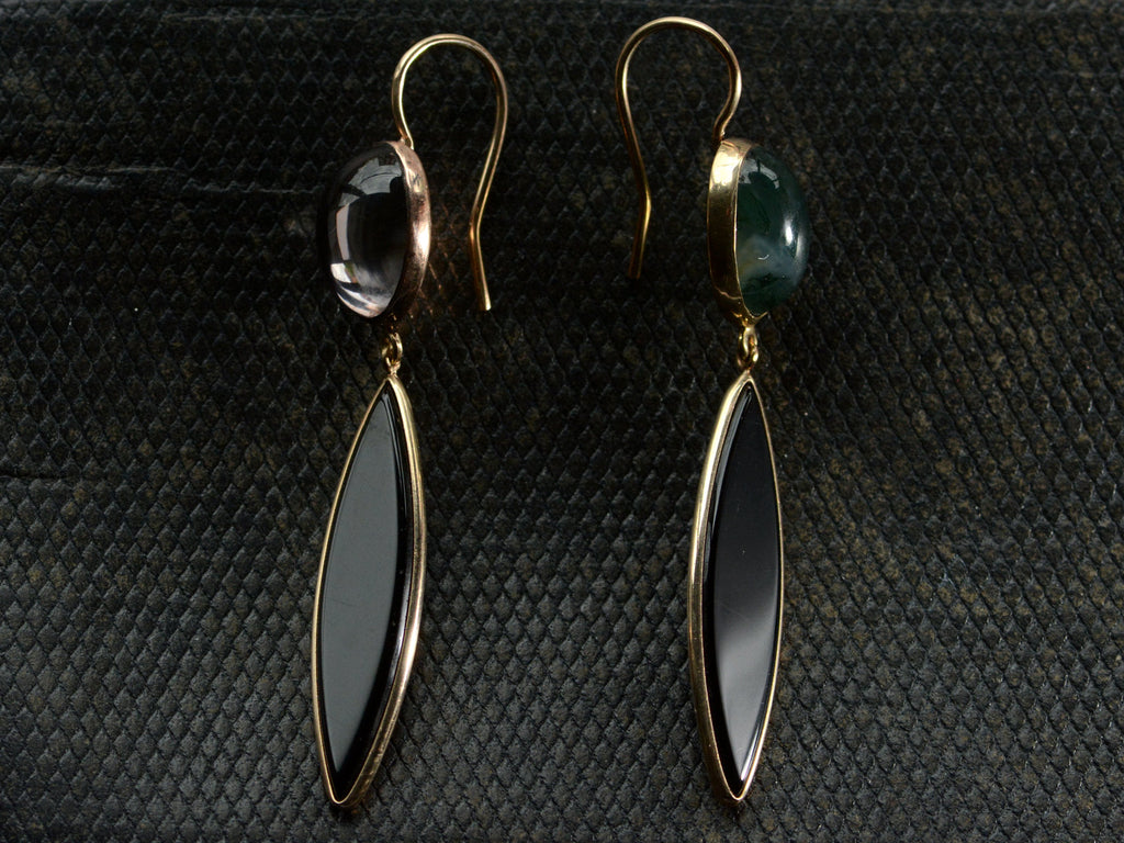 A pair of earrings with mismatched tops of moss agate and pink foiled rock crystal and navette shaped onyx drops, shown dark textured background.