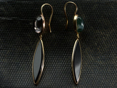 thumbnail of A pair of earrings with mismatched tops of moss agate and pink foiled rock crystal and navette shaped onyx drops, shown dark textured background.