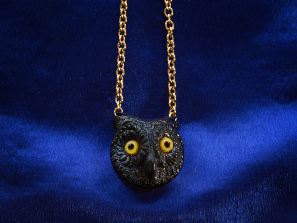 EB Black Glass Owl Pendant Necklace in Yellow Gold (detail on dark blue background)