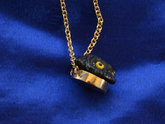 thumbnail of Side profile of EB Black Glass Owl Pendant Necklace in Yellow Gold (detail on dark blue background)