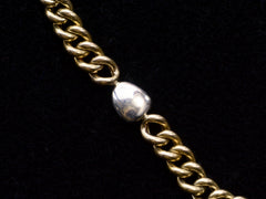 thumbnail of Close up of reverse side of platinum diamond setting and yellow gold curb link chain, on black background.