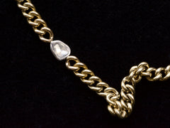 thumbnail of Close up of front of curb link yellow gold chain necklace with a platinum bezel set rose cut diamond, shown on black background.