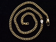 thumbnail of Curb link yellow gold chain necklace with a platinum bezel set rose cut diamond, shown on spiraled on black background.