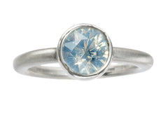 thumbnail of Simple round opalescent light blue sapphire in a platinum bezel with a rounded matte platinum shank, shown on white background.