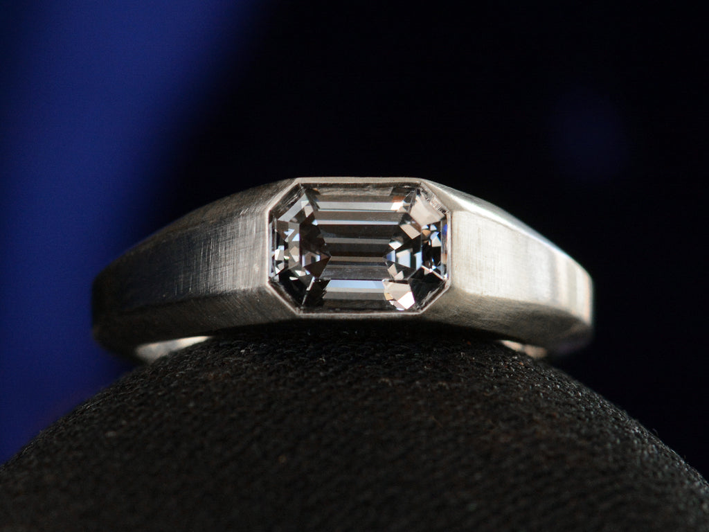 Front view of EB Purple Spinel Signet Ring In Platinum (shown on black background)