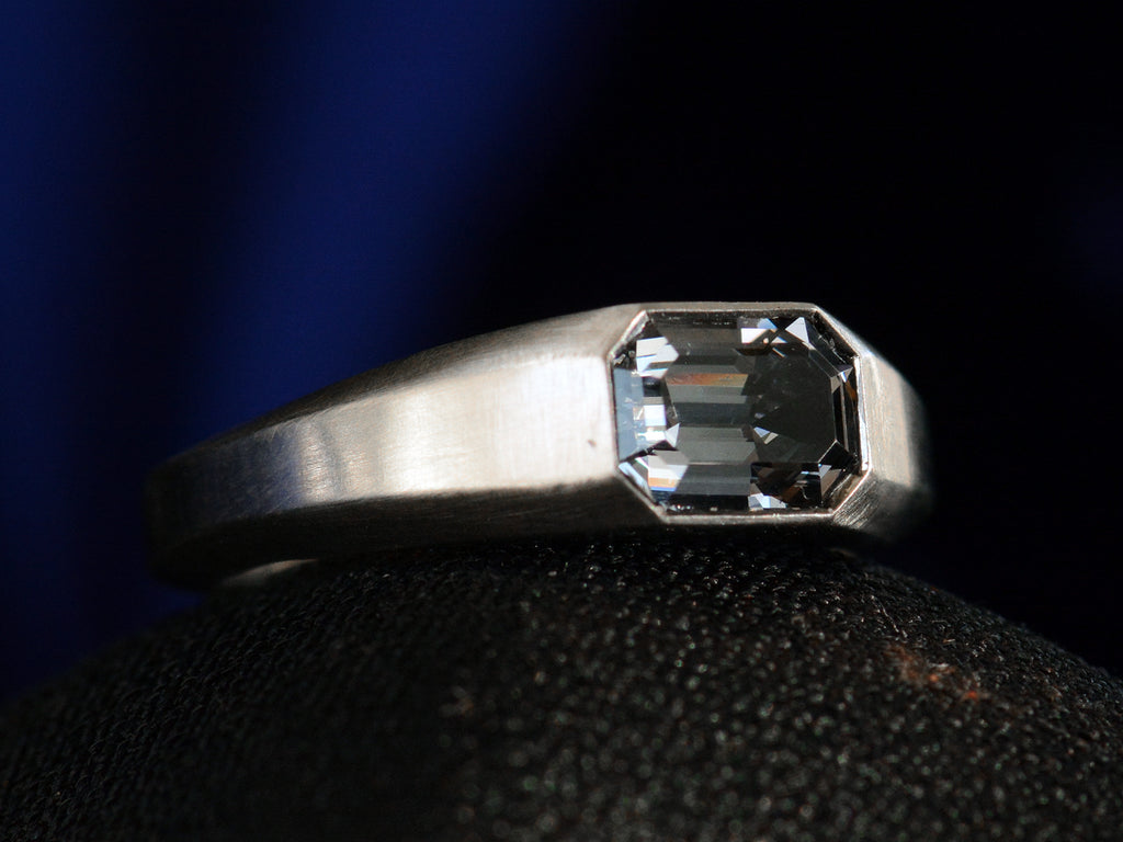 Left angle view of EB Purple Spinel Signet Ring In Platinum (shown on black background)