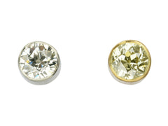 thumbnail of Pair of EB Modern old European cut diamond studs, mismatched with a white diamond in platinum and a yellow diamond in 22K yellow gold. Shown on white background.