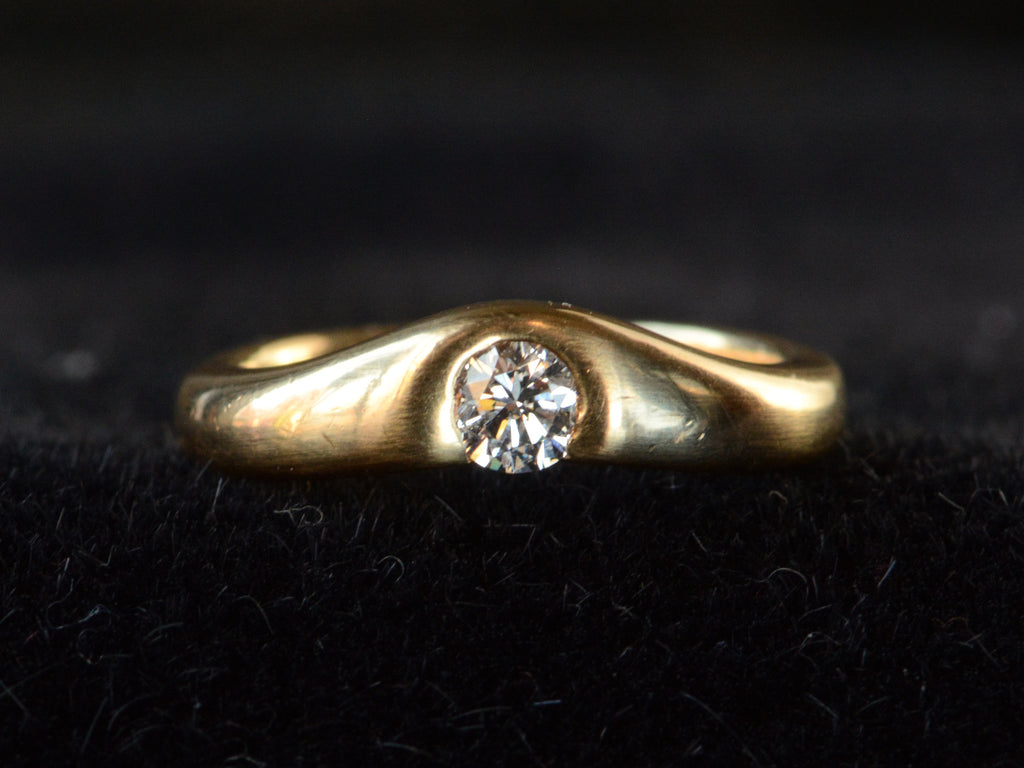 Front profile of vintage Tiffany & Co Elsa Peretti diamond ring in yellow gold shown on dark background.
