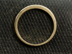 thumbnail of Side profile of gold ring on dark textured background.