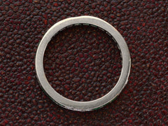 thumbnail of Side profile of vintage platinum eternity ring  on dark textured background.

