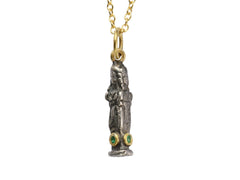 thumbnail of A small three sided figural pendant in silver and 22K yellow gold with emeralds, shown on white background.