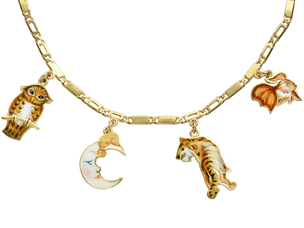 c1970 Enamel Charms Necklace (an owl, a moon, a tiger and a goldfish) in yellow gold. On a white background.