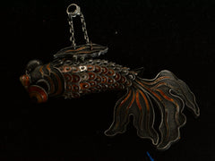 thumbnail of A vintage c1950 Chinese articulated fish pendant with orange enamel and filigree, shown on dark background.