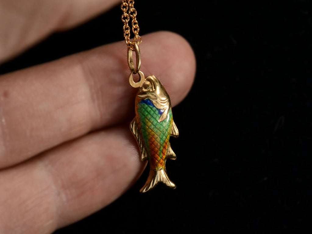 Detail of c1970 Blue, Green and Orange Enamel Fish Pendant in Gold (held in hand)