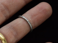 thumbnail of A thin vintage diamond eternity band in platinum, shown on finger