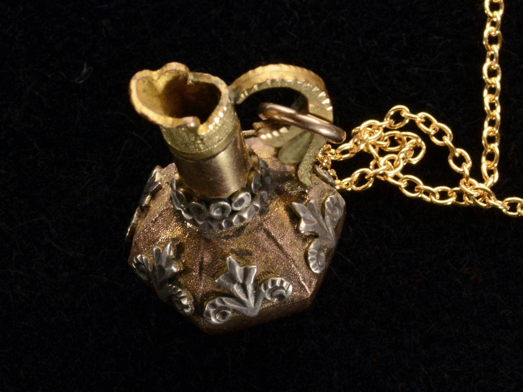 Angled/elevated view of c1900 Turkish Ewer Pendant with Silver and Rose and Green Gold Details. Shown on black background.