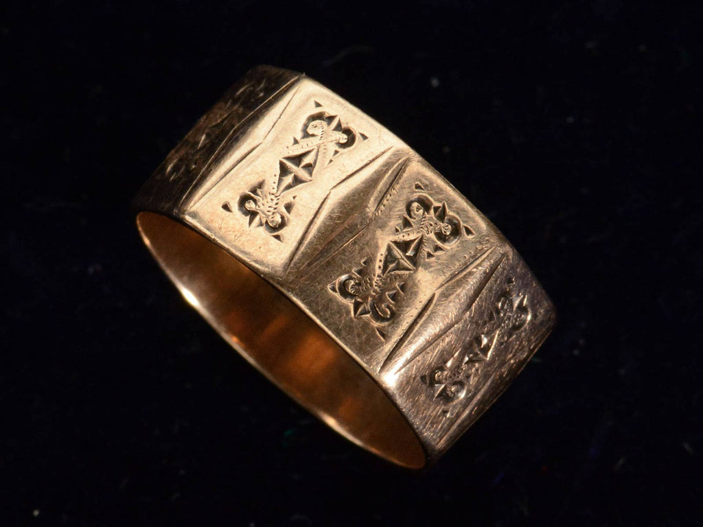 Angled view of c1880 Faceted Cigar Band in Rose Gold (shown on black background)