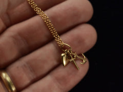 thumbnail of Vintage gold necklace with heart, anchor, and cross pendant on a hand