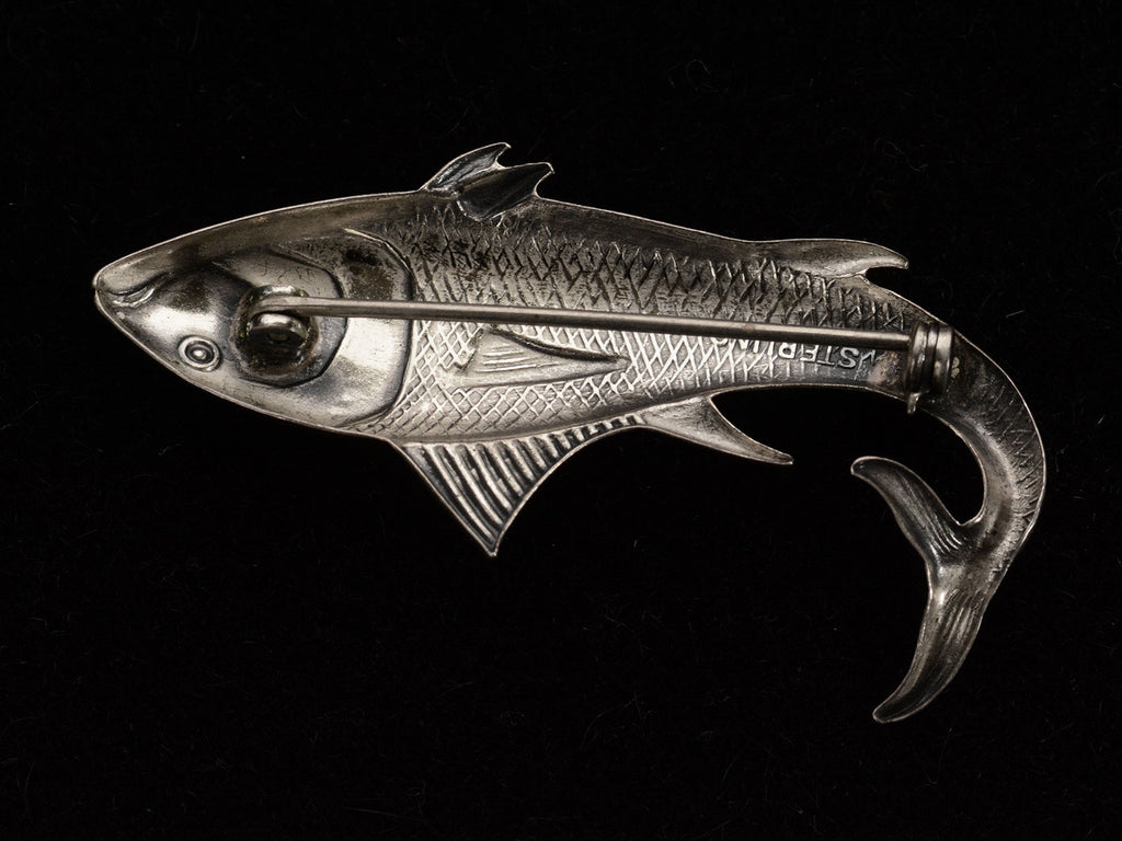 Reverse side of c1950 Silver Fish Brooch (on dark background). "STERLING" stamp partially visible