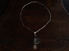 thumbnail of c1970 Silver Fish Skeleton Necklace (shown on dark wood background)