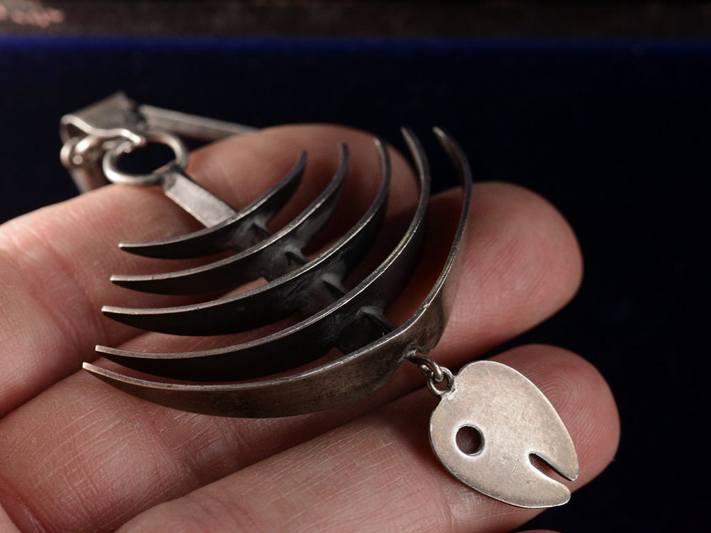 Detail of c1970 Silver Fish Skeleton Pendant (shown on hand for scale)
