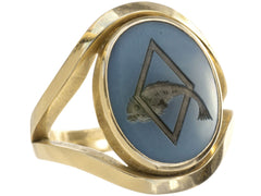 thumbnail of A vintage French yellow gold signet ring with the image of a fish jumping through a lozenge shape carved into blue and black chalcedony. Shown on white background.
