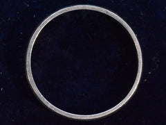 thumbnail of The side profile of a vintage c1980 flat men's wedding band in platinum, shown on dark background