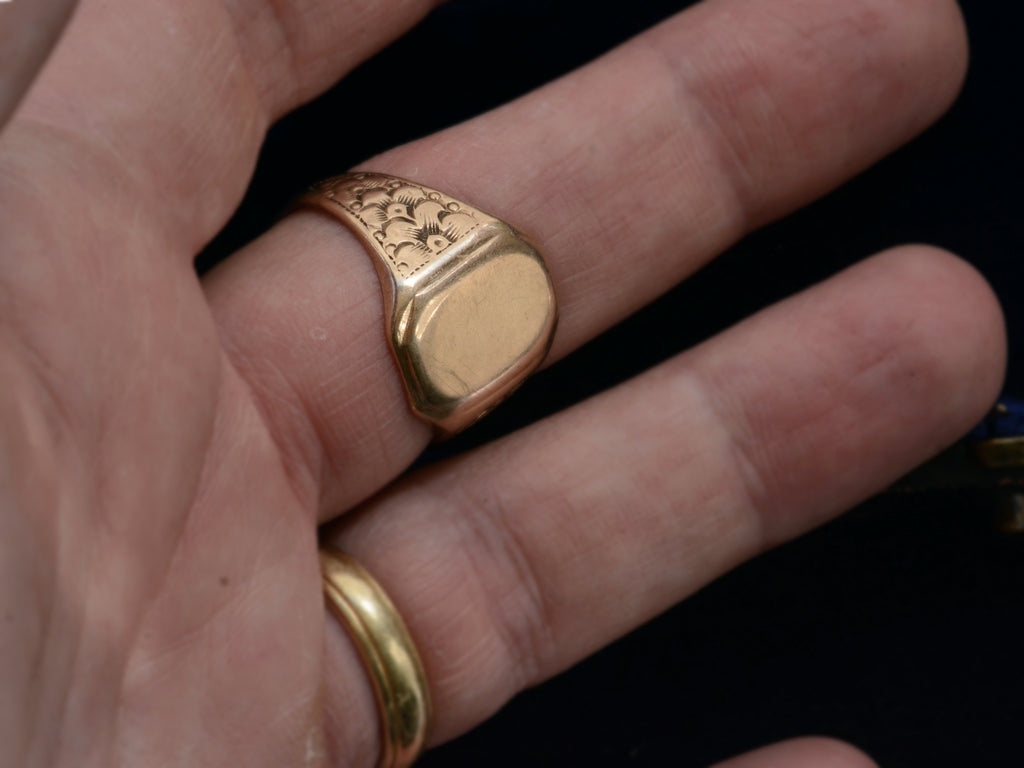 Left Side view of 1900's Men's Floral Rosy Gold Signet Ring (on hand for scale)