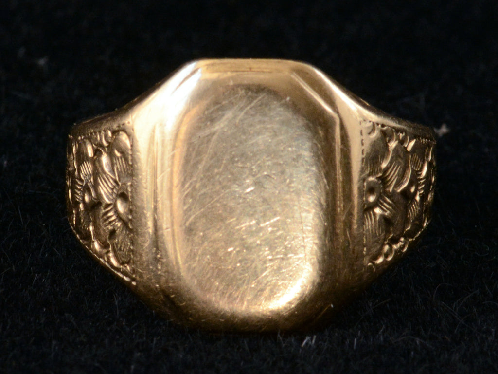 Front-On view of 1900's Men's Floral Rosy Gold Signet Ring (on black background)