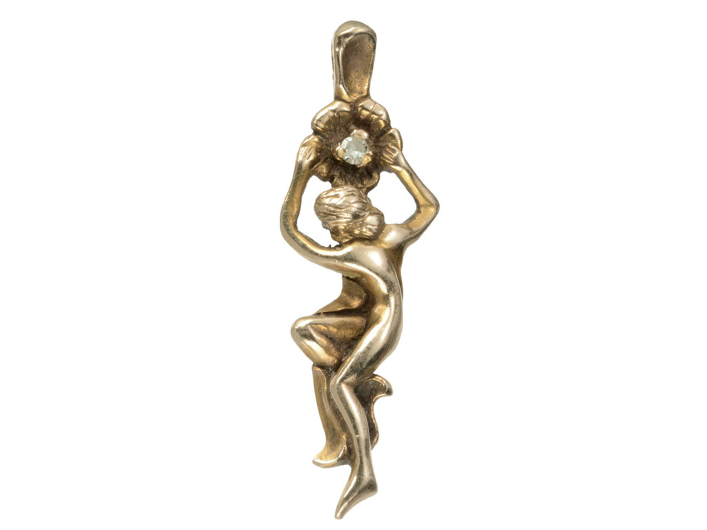 Gold vintage pendant in the form of a a woman hanging from a flower (shown on white background)