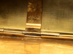 thumbnail of Close-up of a gold washed cigarette case interior with 'STERLING' and number '25' engraving.