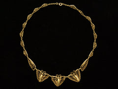 thumbnail of Am antique French gold filigree chain necklace with three butterfly-shaped pendants at the front, displayed against a solid black background.