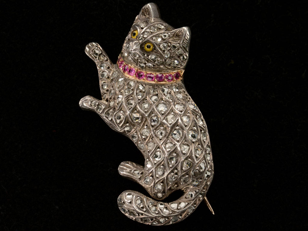 Angled view of c1880 Pet Cat Brooch with Diamond and Rubies (shown on black background)