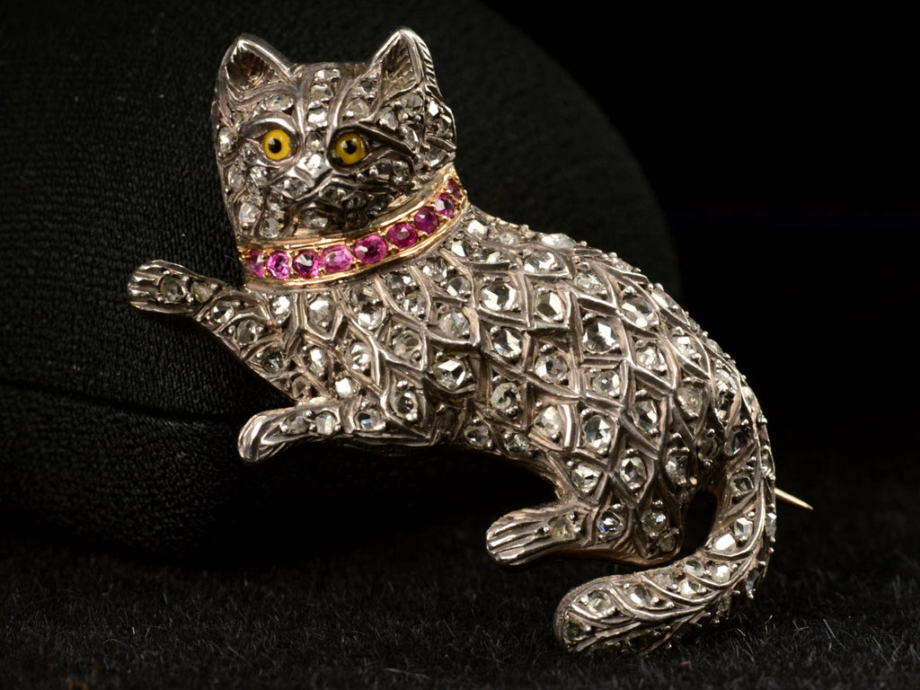 Front view of c1880 Pet Cat Brooch with Diamond and Rubies (shown against a jewelry box)