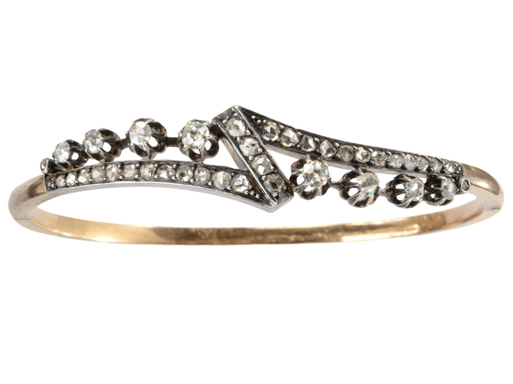 An antique French silver topped yellow gold bracelet with a zig-zag of rose cut diamonds, shown on white background.