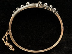 thumbnail of Side profile of an antique French silver topped yellow gold bracelet with a zig-zag of rose cut diamonds, shown on black background.