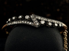 thumbnail of An antique French silver topped yellow gold bracelet with a zig-zag of rose cut diamonds, shown on black background.