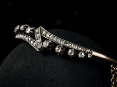 thumbnail of Angled view o an antique French silver topped yellow gold bracelet with a zig-zag of rose cut diamonds, shown on black background.