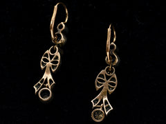 thumbnail of Reverse sides of a pair of c1890 Victorian drop earrings with old European cut diamonds set in silver topped gold with a bow design. Shown on black background.