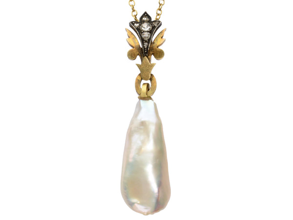 Detail of antique pendant with rose cut diamond and yellow gold top and large baroque pearl drop (shown on white background)