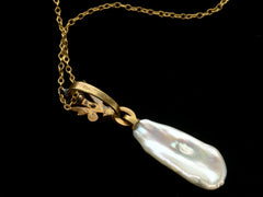 thumbnail of Reverse side of antique pendant with rose cut diamond and yellow gold top and large baroque pearl drop (shown on dark background)