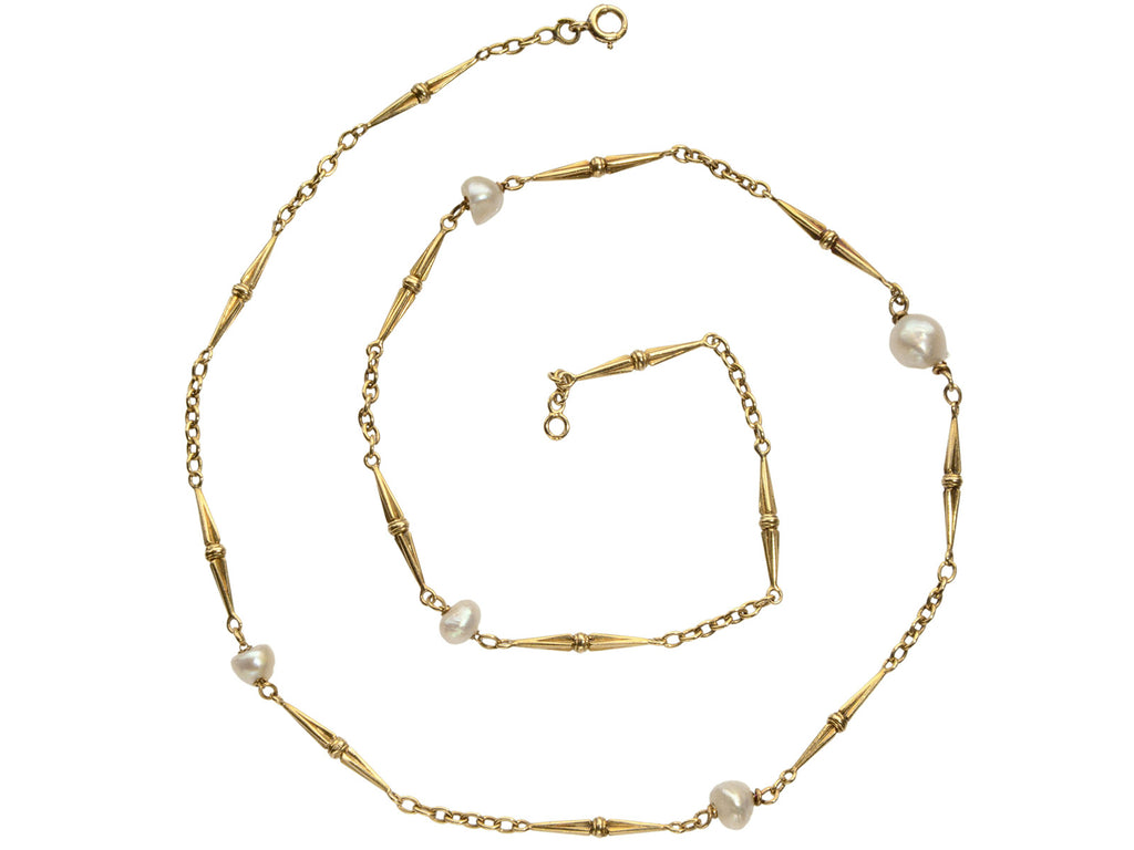 Detail of c1920 French Art Deco gold chain necklace with interspersed pearls, shown spiraled on white background