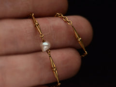 thumbnail of Close up detail of c1920 French Art Deco gold chain necklace with interspersed pearls, shown on hand.