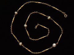 thumbnail of Detail of c1920 French Art Deco gold chain necklace with interspersed pearls, shown spiraled on black background