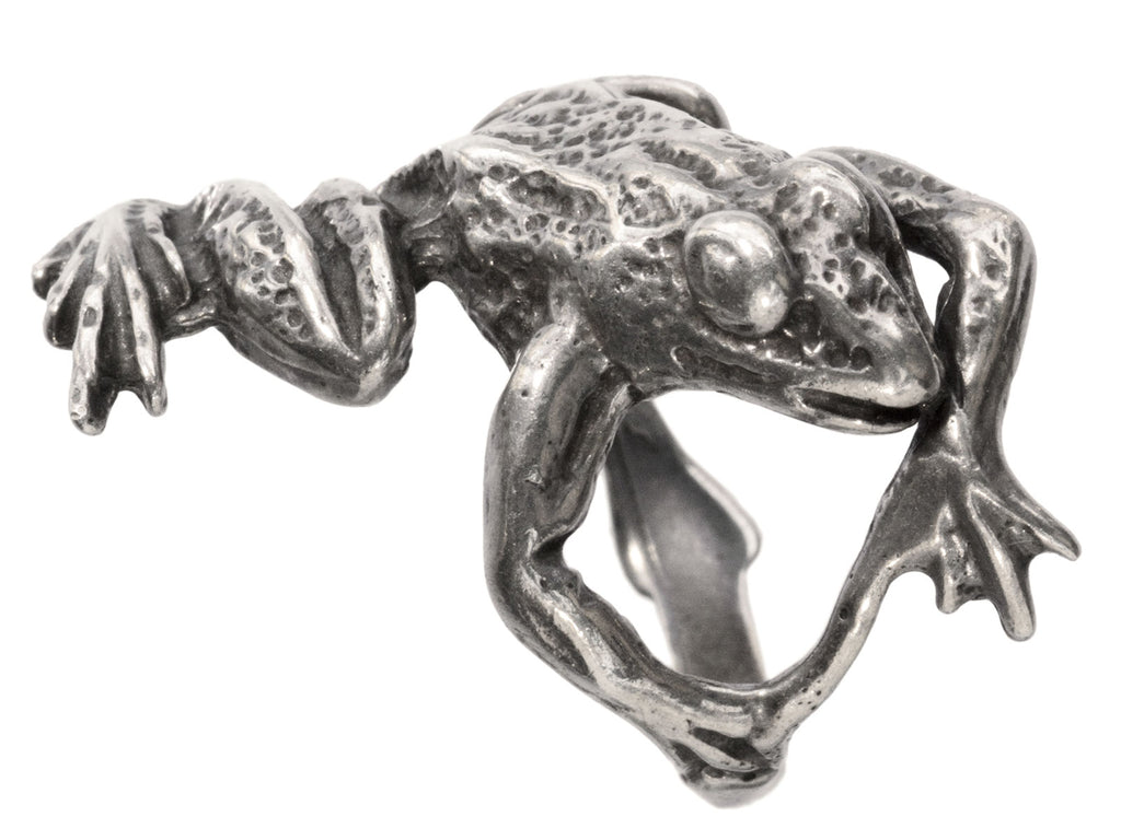 Angled detail view of figural silver frog ring, shown on white background.