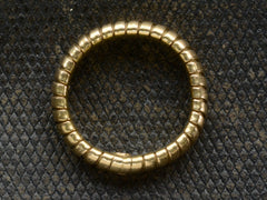thumbnail of Side profile of a flexible gaspipe-link 18k yellow gold band, shown on dark background.