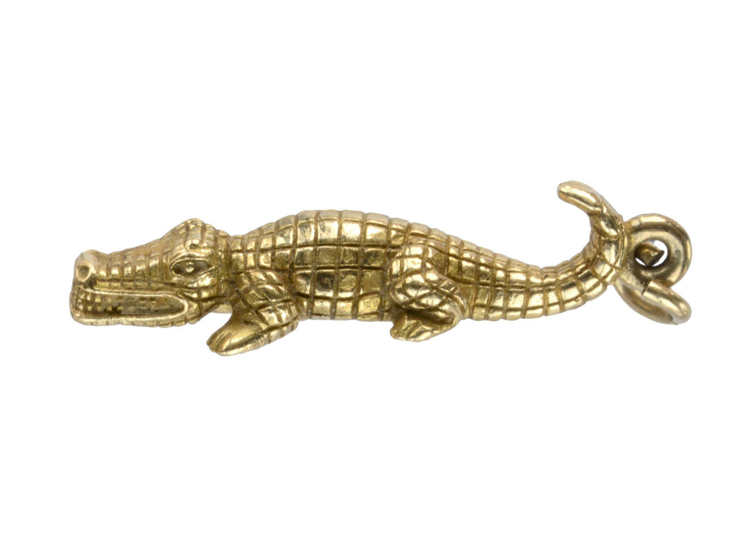 Gold alligator-shaped pendant on a white background